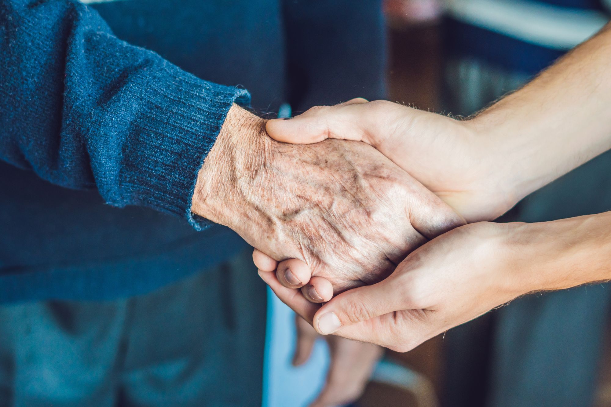 A person holding the hand of a person.