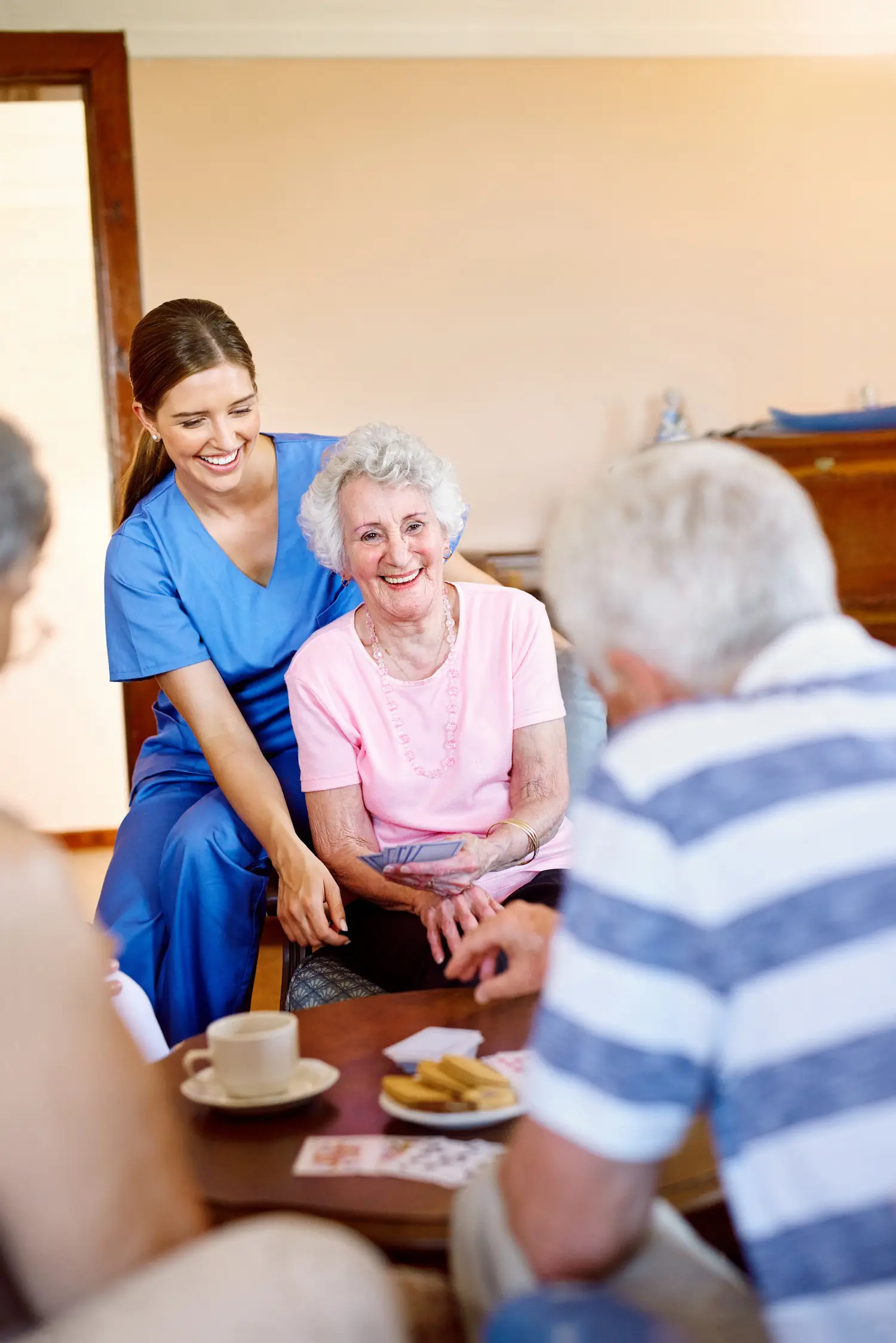A group of people sitting around a table with a caregiver.